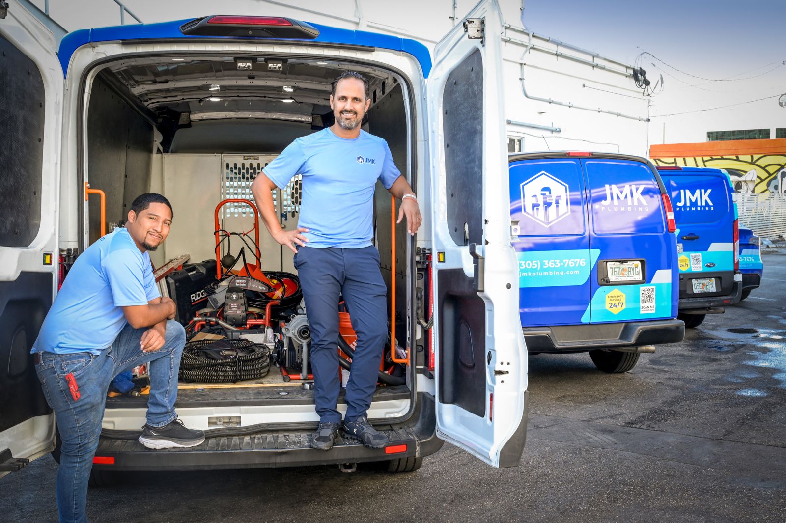 JMK Plumbing Team in a van with tools