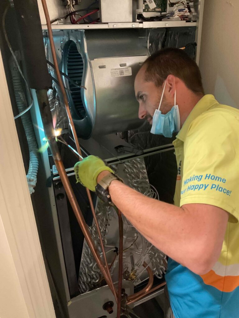 Sunny Bliss Miami AC technician installing a new air conditioning system