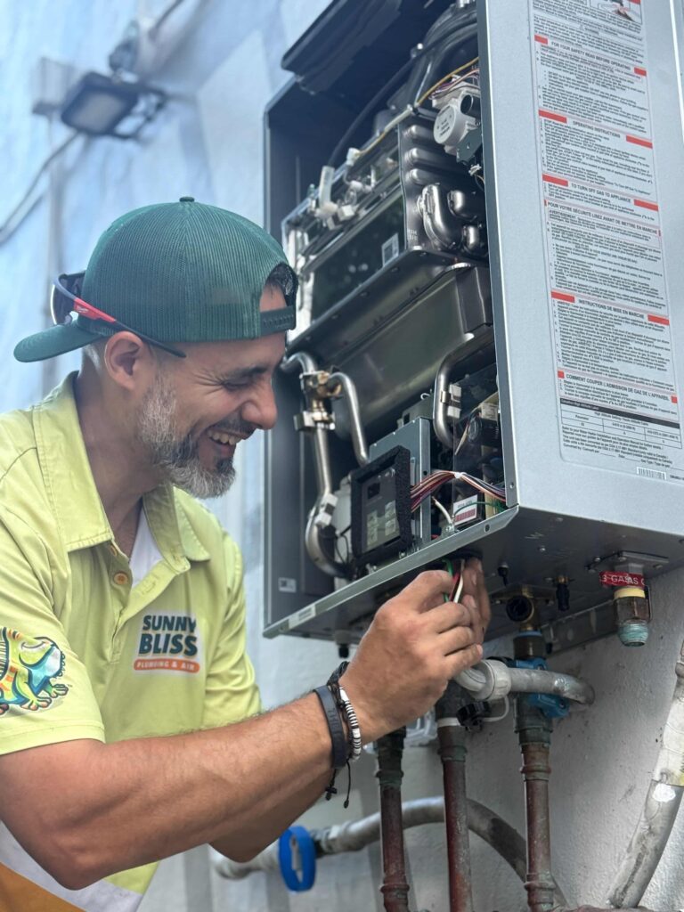 Licensed Miami plumber installing a Rinnai water heater